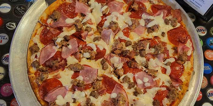 Meat lovers specialty pizza from lunch and dinner menu at Pineland Grille in Arkdale WI